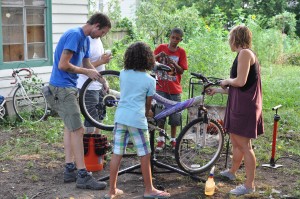 Volunteers teaching kids basic bike maintenance.